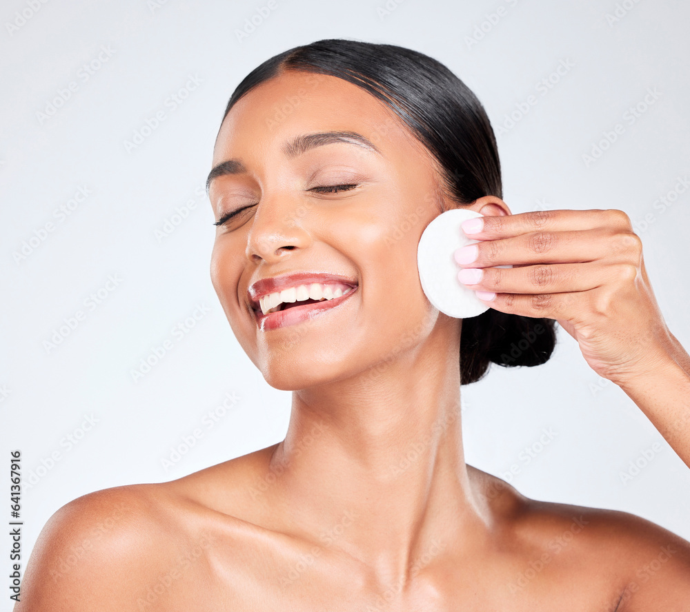 Beauty, skincare and woman with cotton pad on face for makeup cleaning and cosmetics in studio. Derm