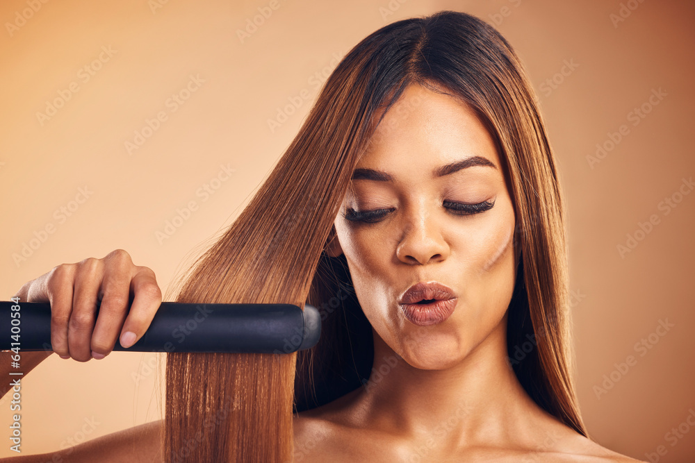 Excited, hair straightener and a woman in studio for beauty, cosmetics or appliance. Aesthetic model