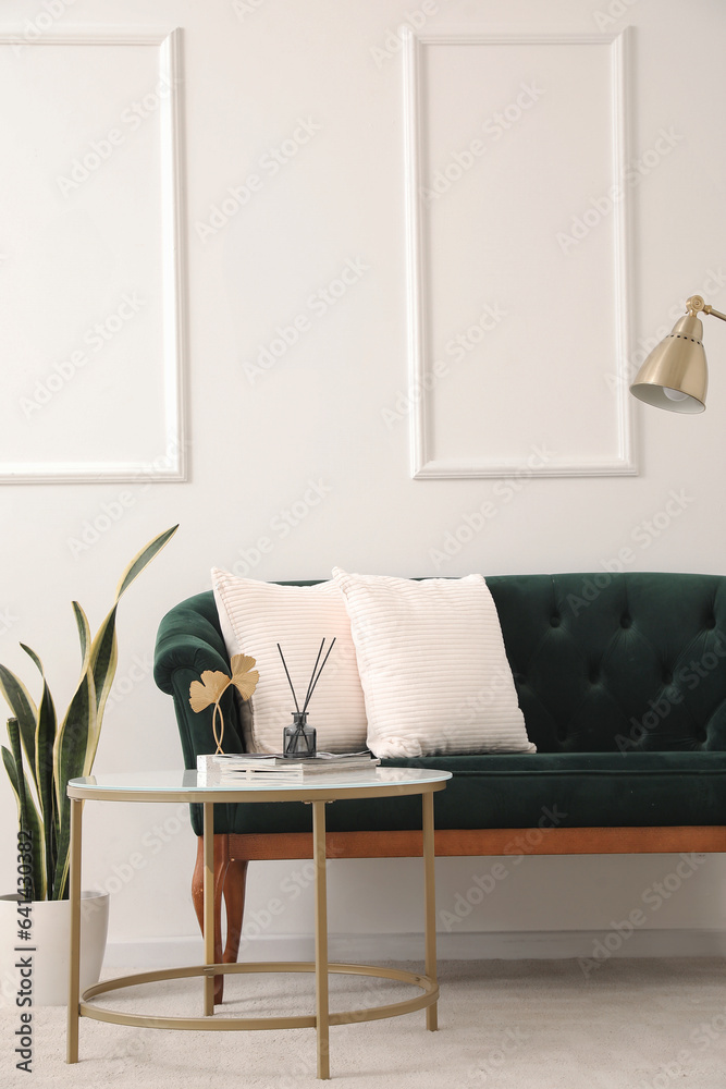 Interior of living room with green sofa and table