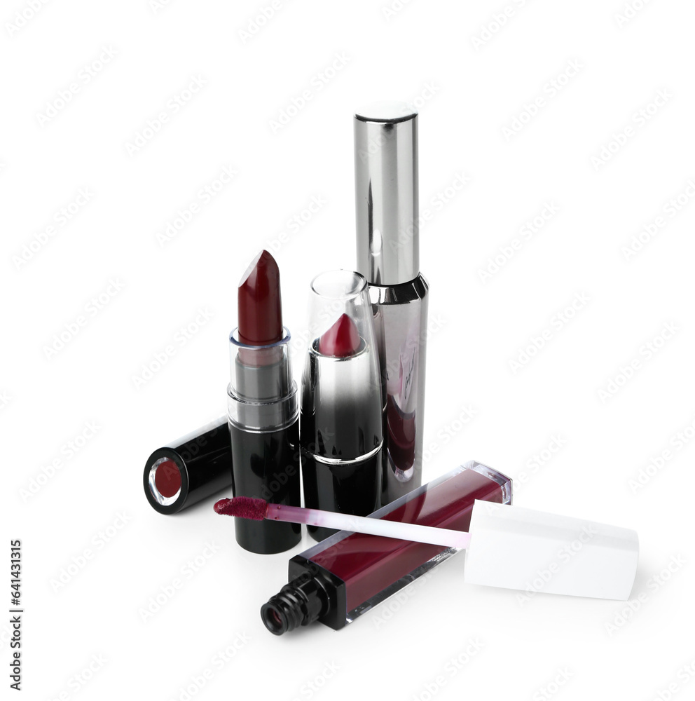 Lipsticks with mascara on white background