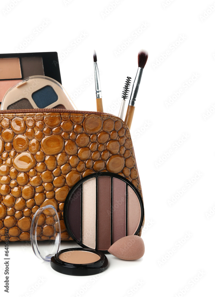 Stylish bag with decorative cosmetics and makeup brushes on white background, closeup