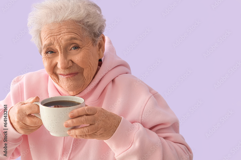 Senior woman with cup of hot coffee on lilac background, closeup