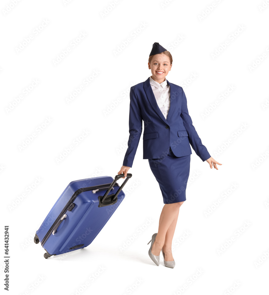 Beautiful stewardess with suitcase on white background