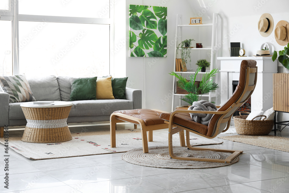 Interior of cozy living room with sofa, armchair and fireplace