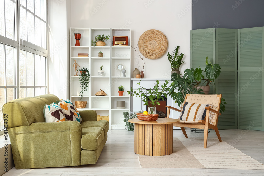 Interior of bright living room with cozy sofa and coffee table near big window