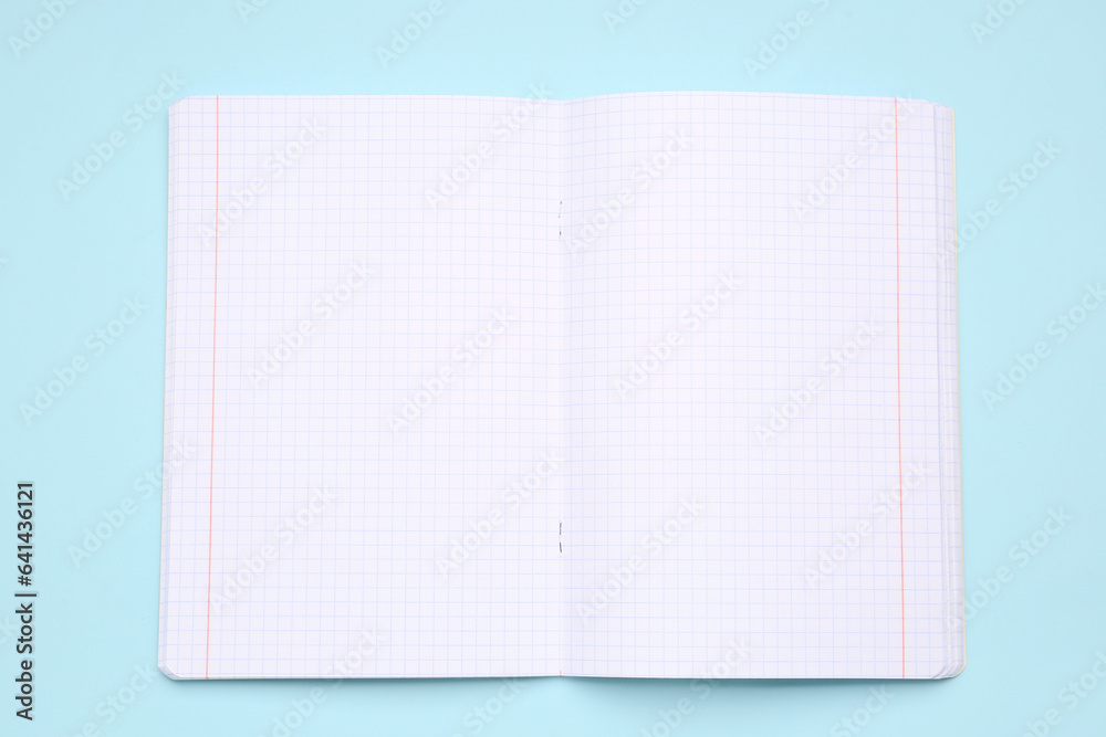 Blank copybook pages on blue background