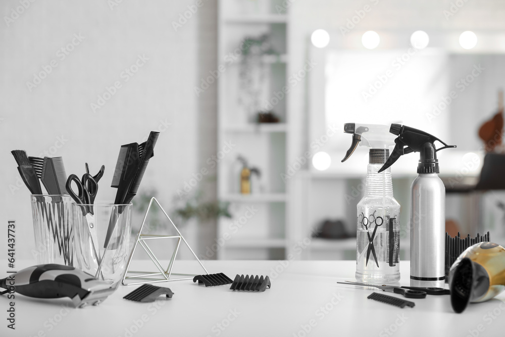 Different hairdressing tools on table in beauty salon