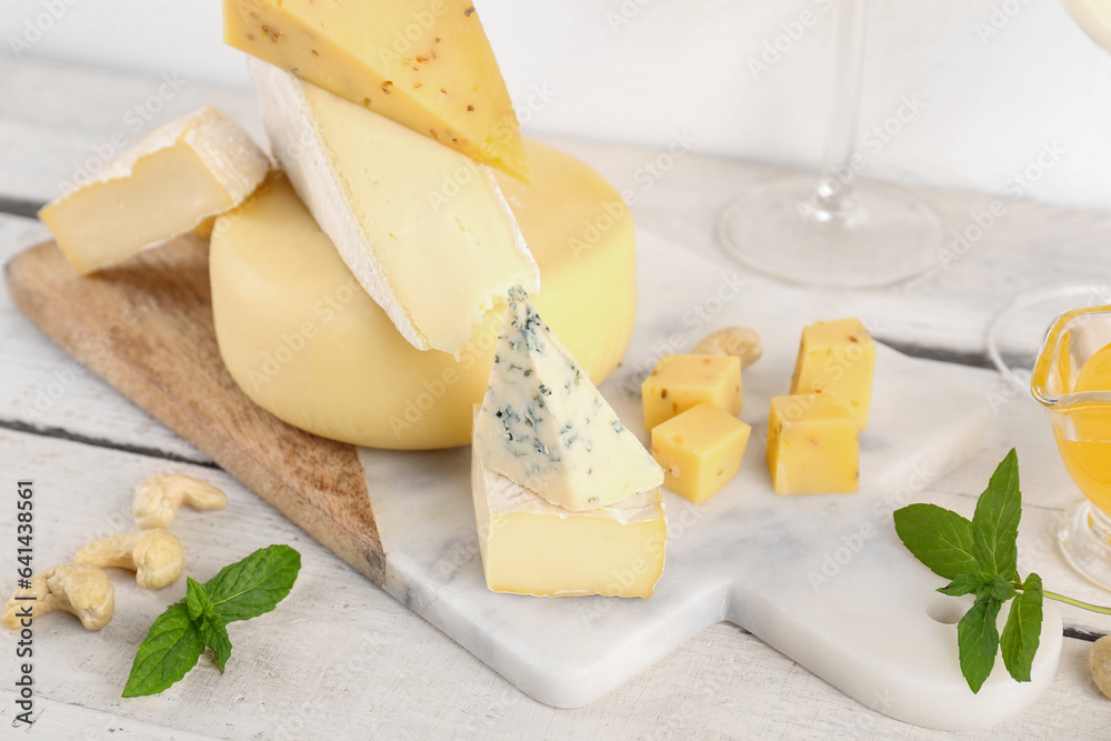 Board with different types of tasty cheese on table