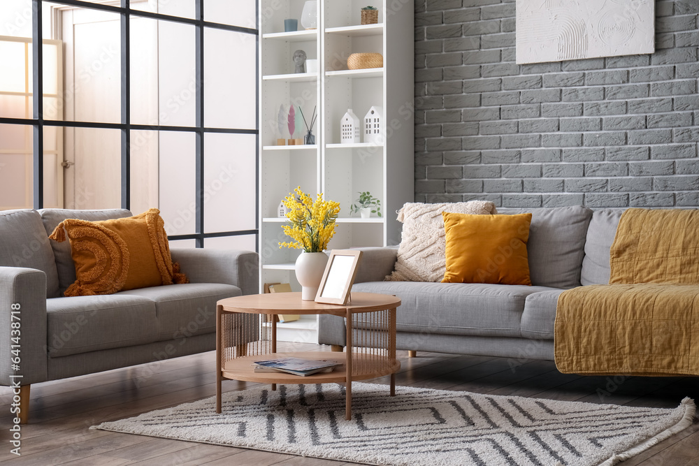 Interior of modern living room with sofas, coffee table and shelving unit