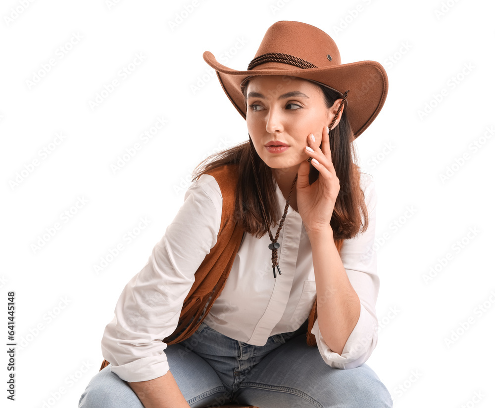 Beautiful cowgirl sitting on white background