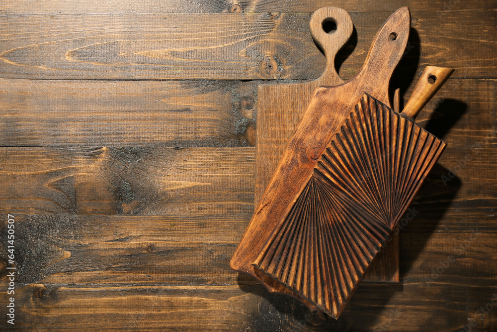 Different cutting boards on wooden background