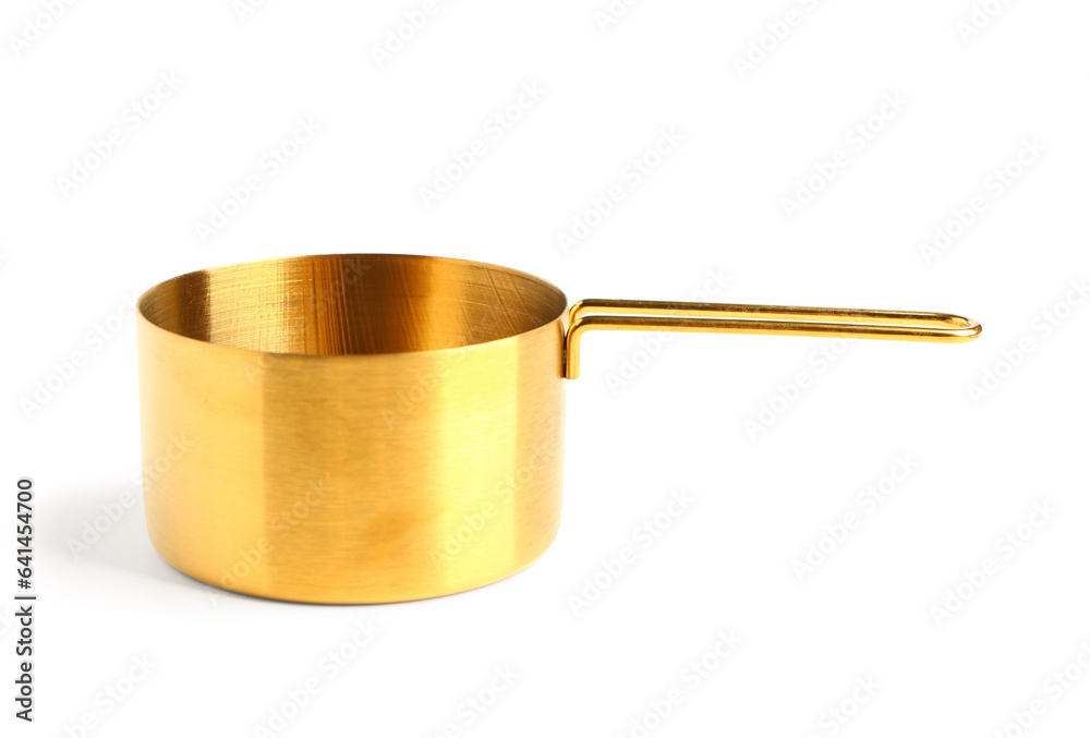 Golden measuring cup on white background