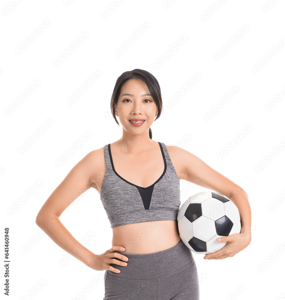 Happy young sporty Asian woman with soccer ball isolated on white background