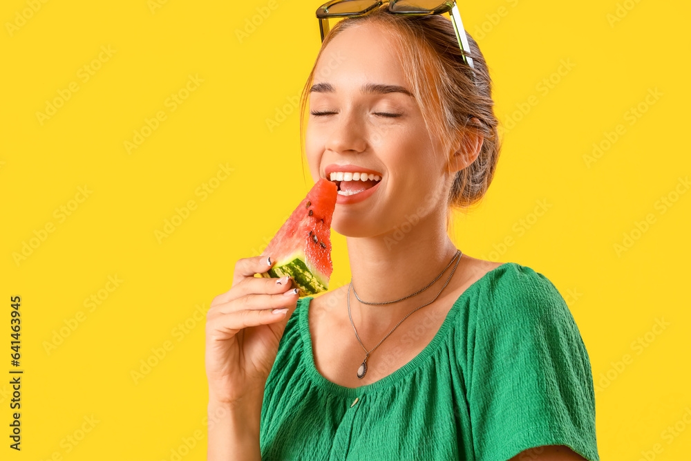 Young woman eating fresh watermelon on yellow background, closeup