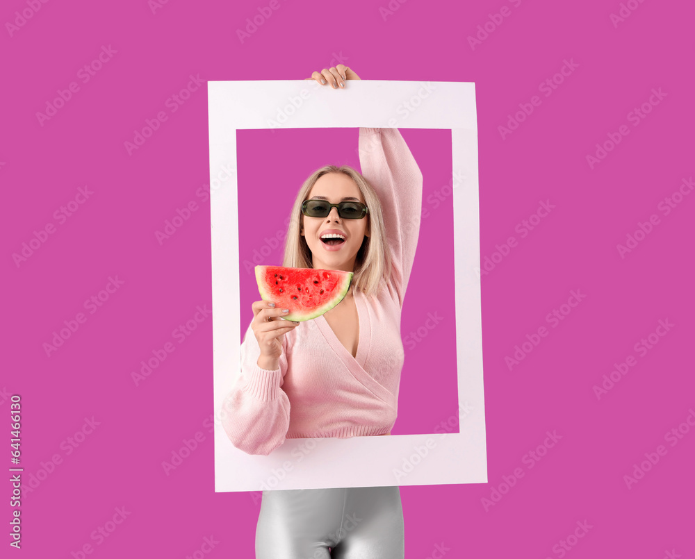 Young beautiful happy woman with slice of fresh watermelon and frame on purple background