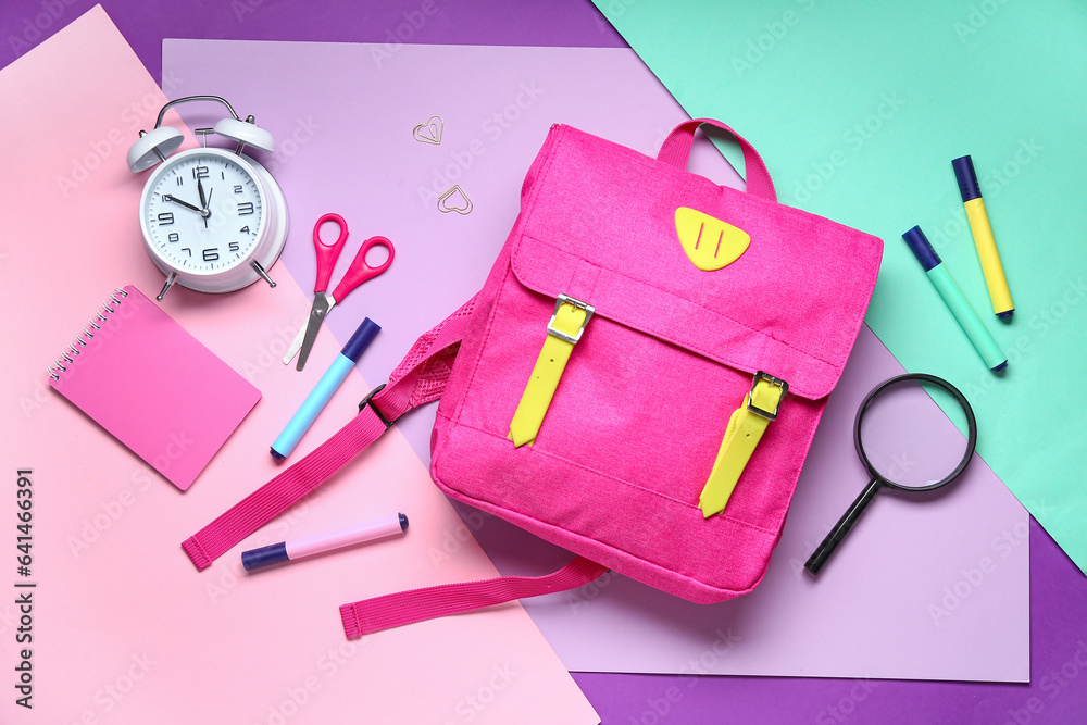 Stylish school backpack with different stationery on color background