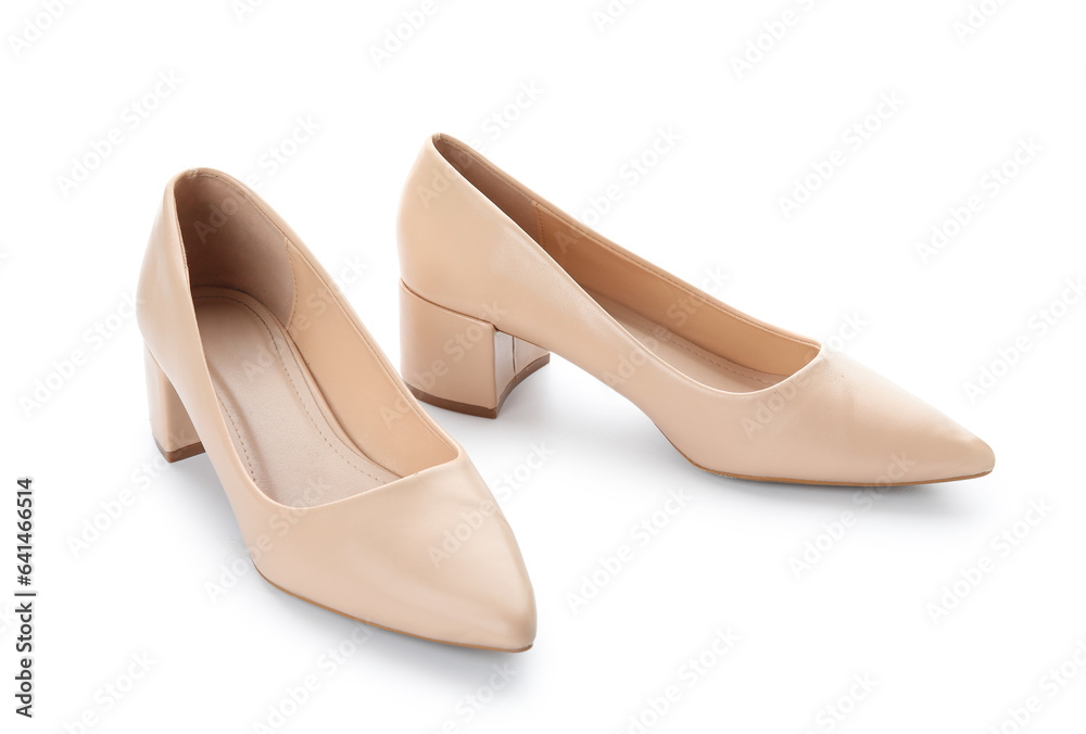 Stylish beige high heels on white background