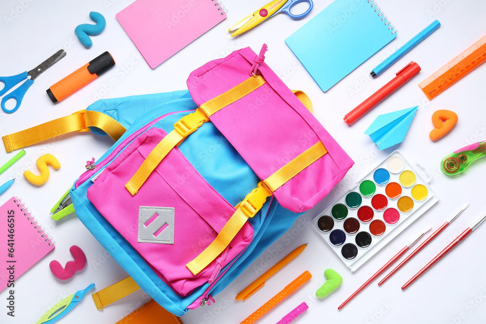 Stylish school backpack and different stationery on white background