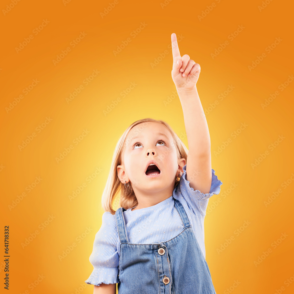 Child, surprise and pointing up with hand in studio for advertising, announcement or promotion. Shoc