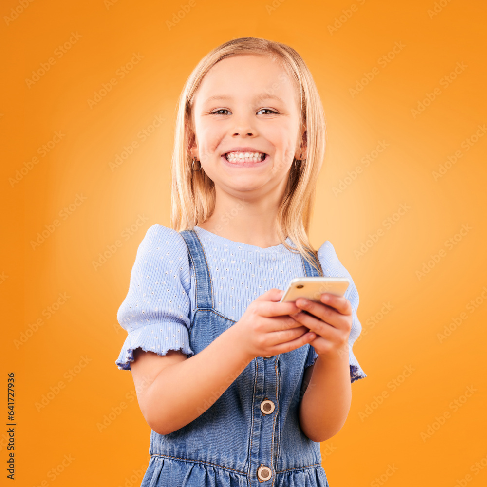 Child, portrait and typing with smartphone in studio for social media, play mobile games and smile o