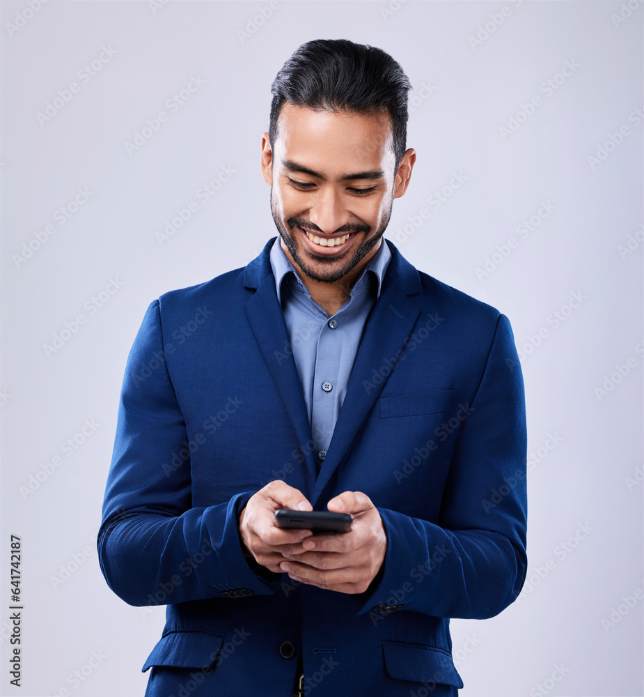 Phone, smile and businessman in studio typing text message on social media, mobile app or the intern