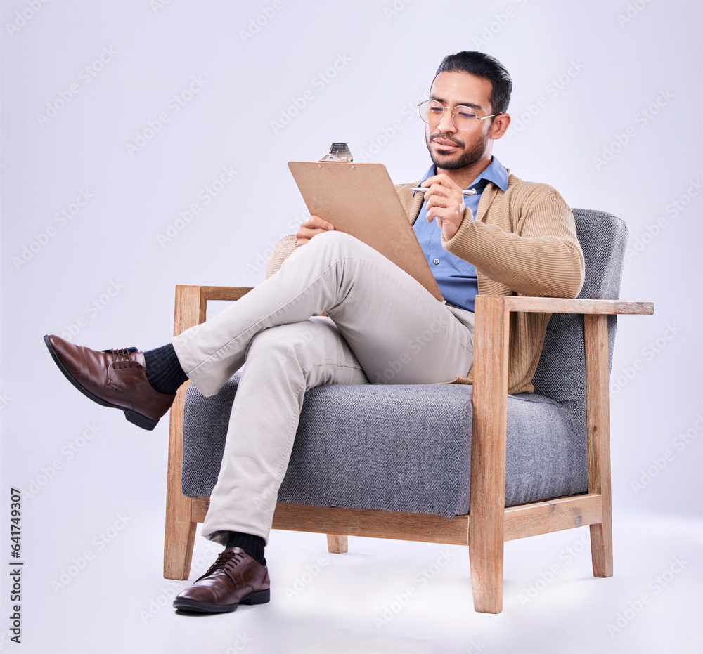 Documents, diagnosis and a man psychologist in a chair on a white background in studio to listen for