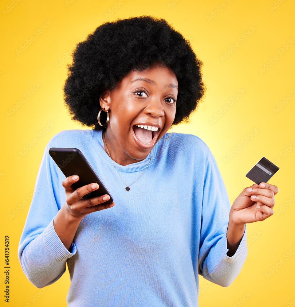 Happy black woman, portrait and phone with credit card in online shopping against a yellow studio ba