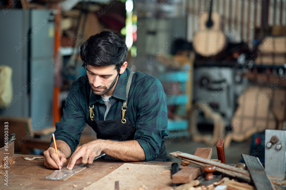 Luthier making a peghead of classical guitar