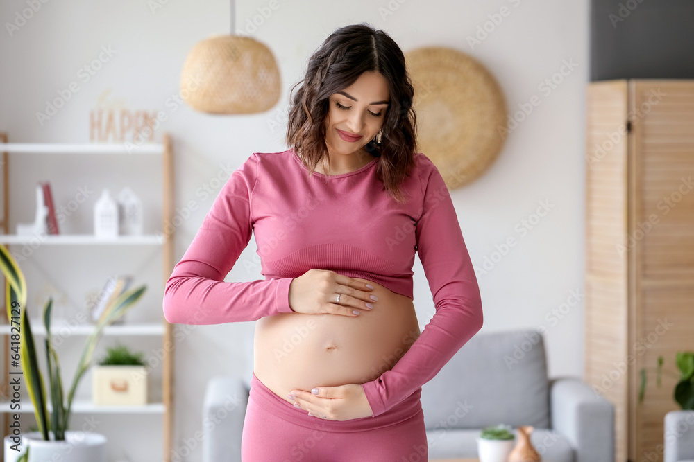 Sporty pregnant woman at home