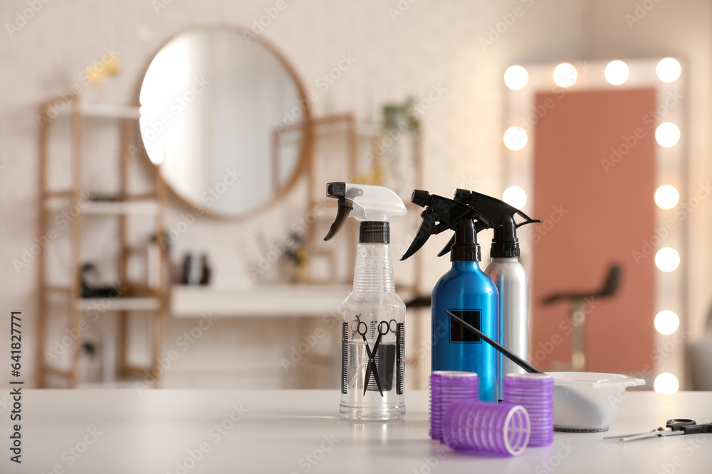 Different hairdressing tools on table in beauty salon