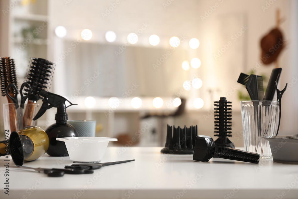 Different hairdressing tools on table in beauty salon