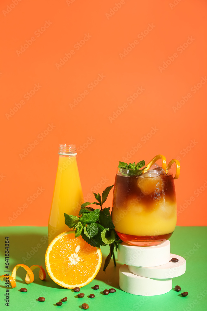 Glass of tasty orange espresso and glass with juice on color background