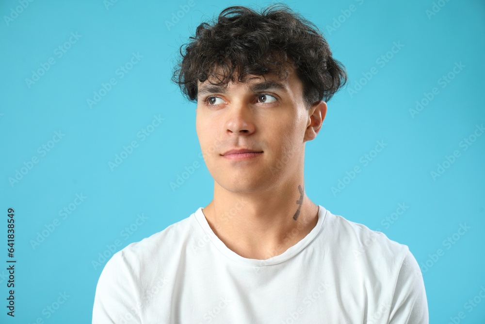 Portrait of handsome young man on blue background