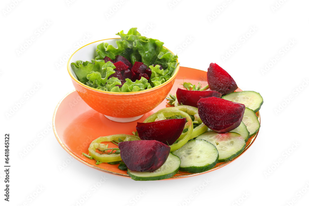 Plate of fresh vegetable salad with beet on white background