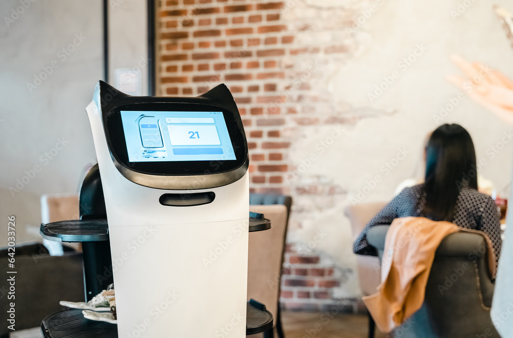 Robot waiter serve food at modern restaurant table.Offering innovation futuristic high-tech automate