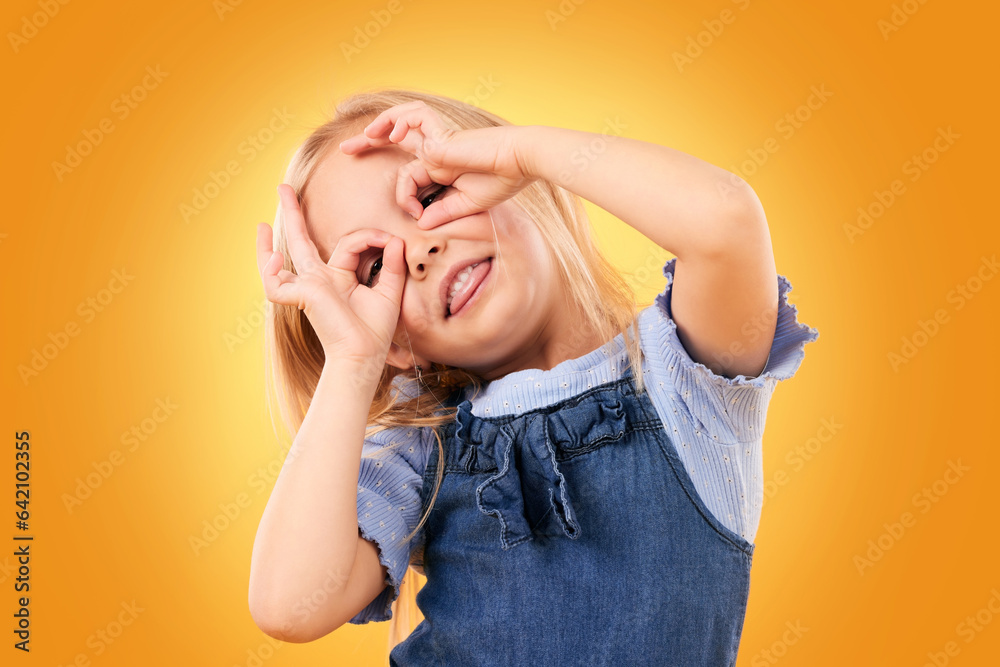 Kids, fun and hand glasses by girl in studio playing, free and funny gesture against orange backgrou