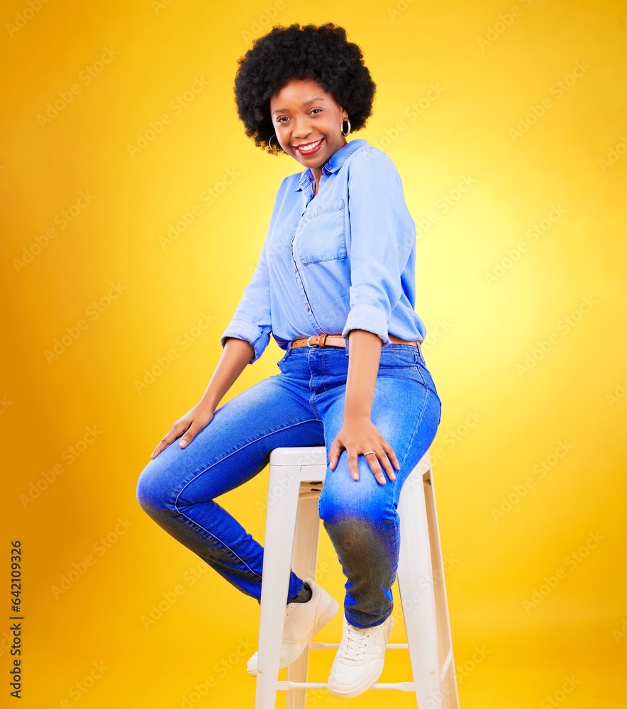 Happy, portrait and black woman on chair with fashion, casual style and natural confidence on yellow