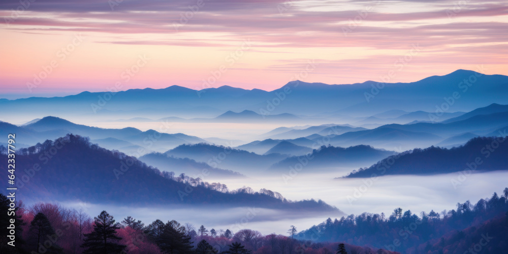 The mountains are shrouded in mist. A twilight shot of autumn mountains under a fading red orange pu