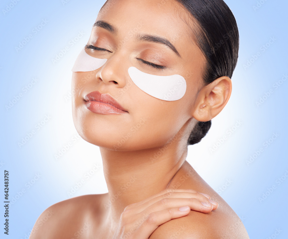 Skincare, beauty and woman with eye pads for anti aging or skin glow on blue background. Cosmetics, 