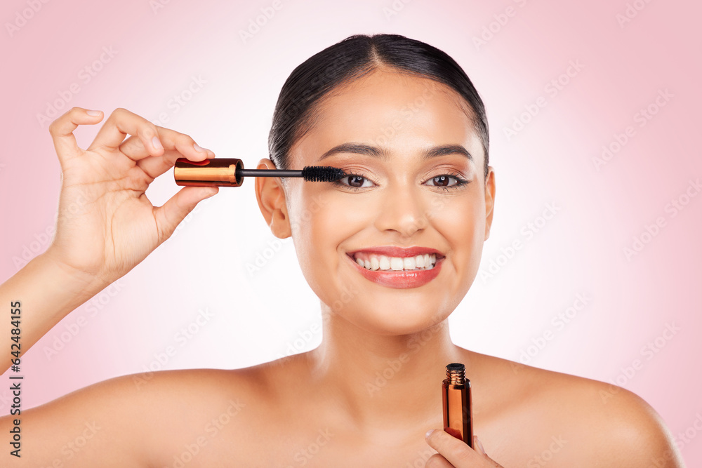 Portrait, smile and a woman with mascara on a pink background for eyelash beauty in studio. Smile, y