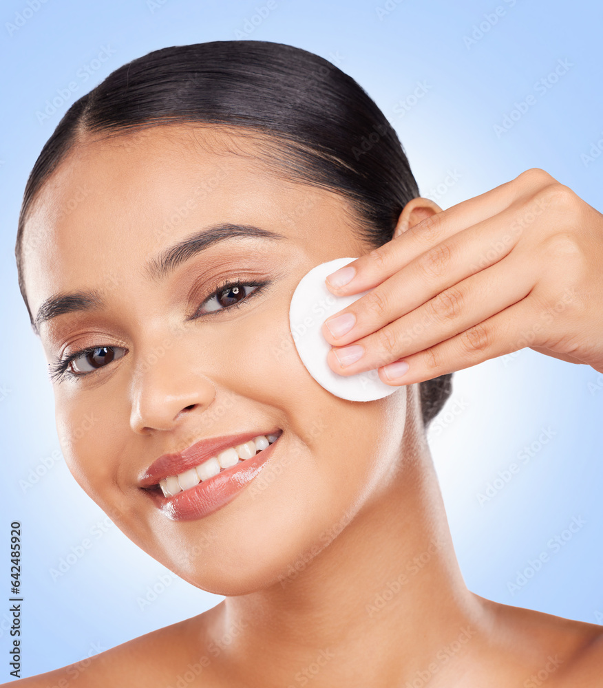 Woman, face portrait and cotton pad in studio for skincare, cosmetics or aesthetic glow on blue back