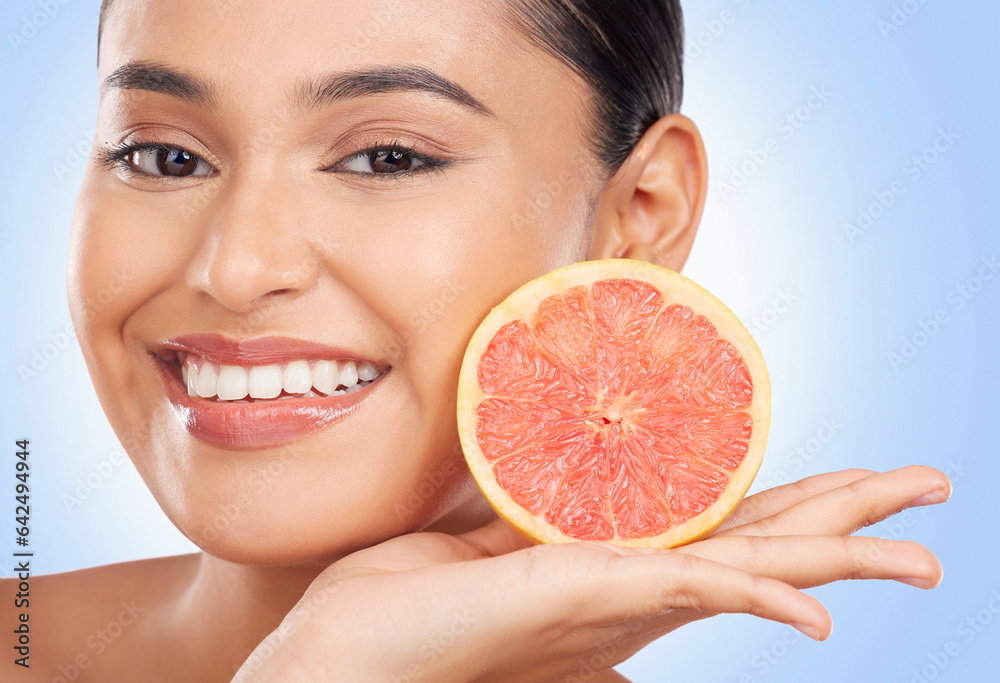 Portrait, beauty and grapefruit with a natural woman in studio on a blue background for health or we