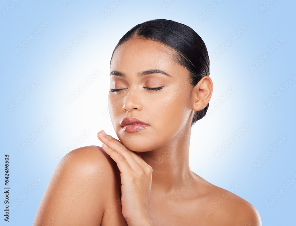 Skincare, beauty and woman with cosmetics, wellness and dermatology on a blue studio background. Sel