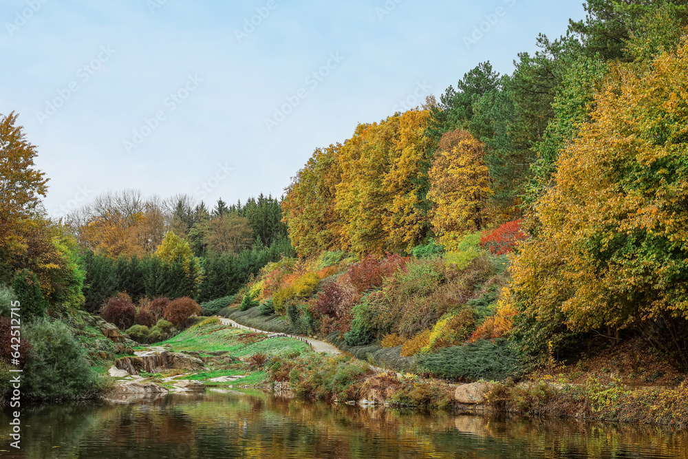 View of beautiful autumn park with lake and trees