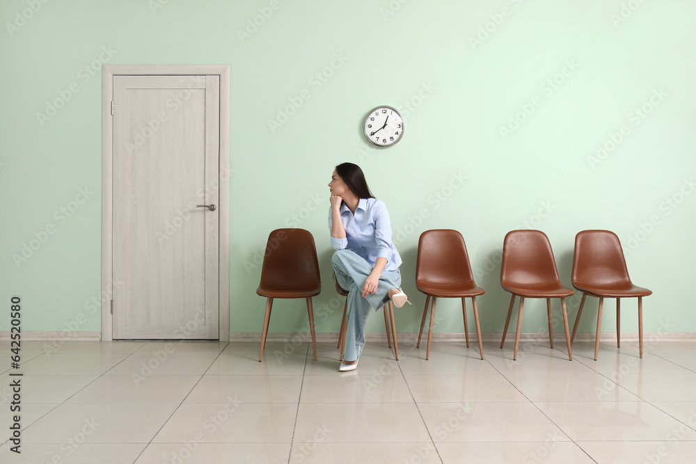 Young woman waiting for job interview in room