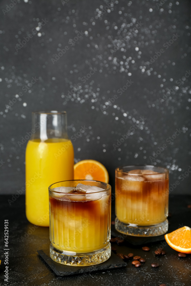 Glasses of cold orange espresso on table