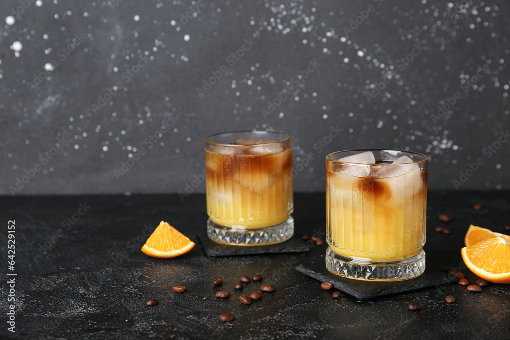 Glasses of cold orange espresso on table