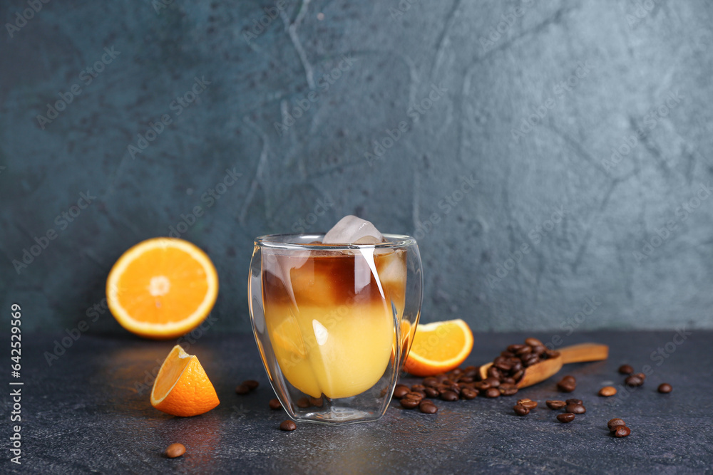 Glass of cold orange espresso on dark blue background