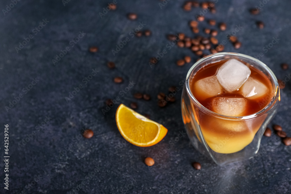 Glass of cold orange espresso on dark blue background