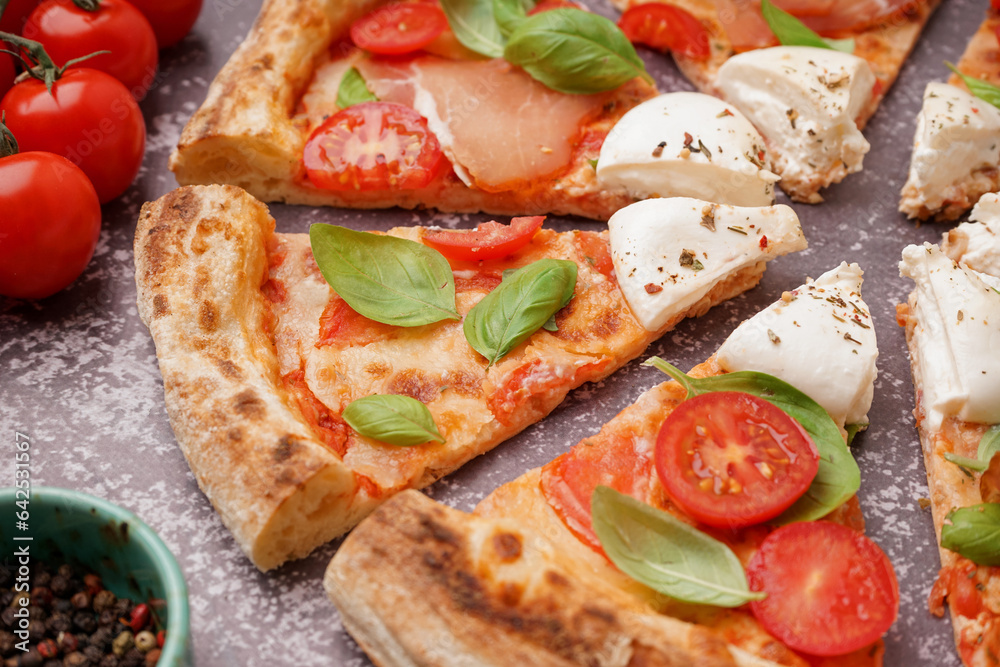 Slices of tasty pizza with Burrata cheese on grey background